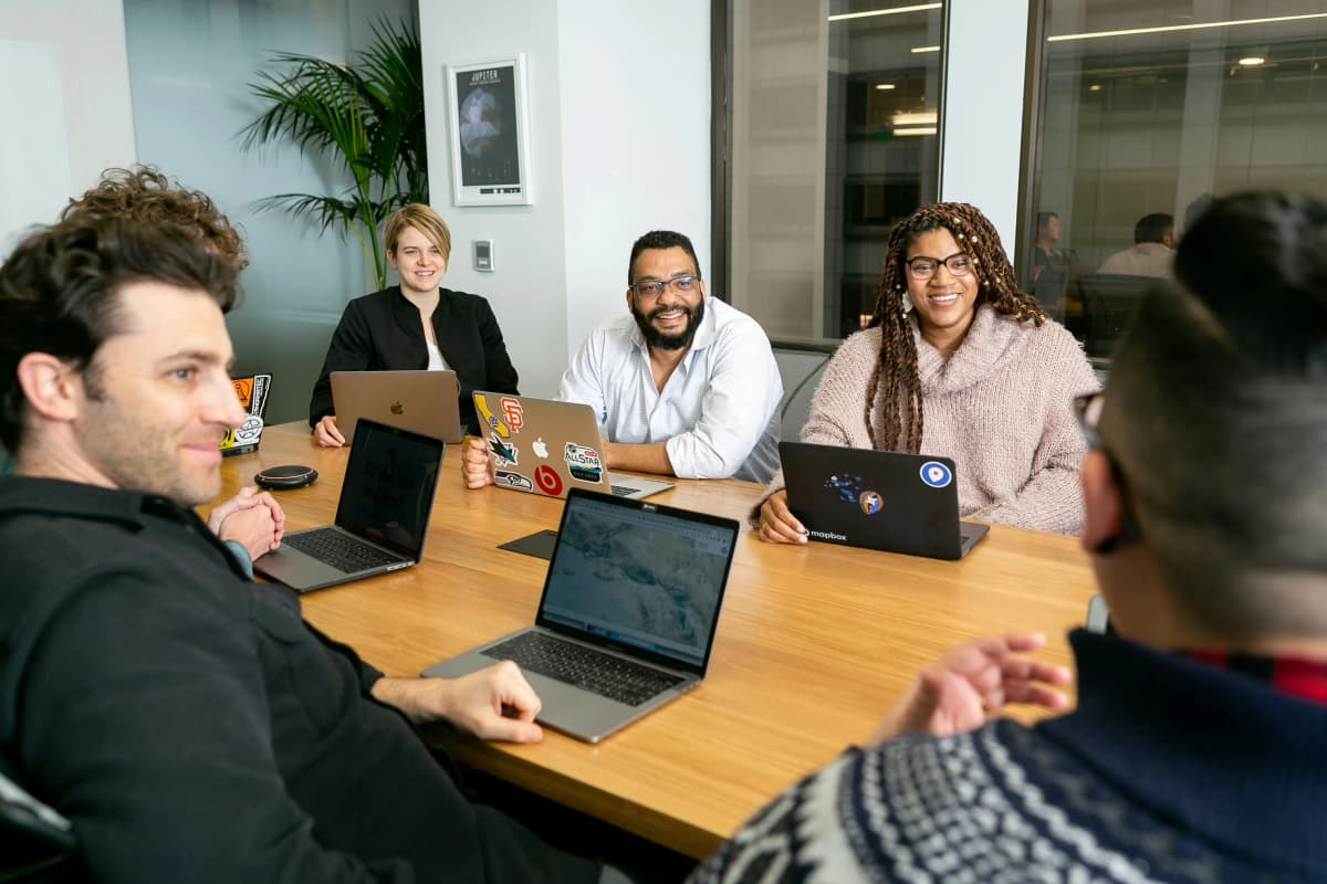 International executive leading business meeting with Spanish-speaking team